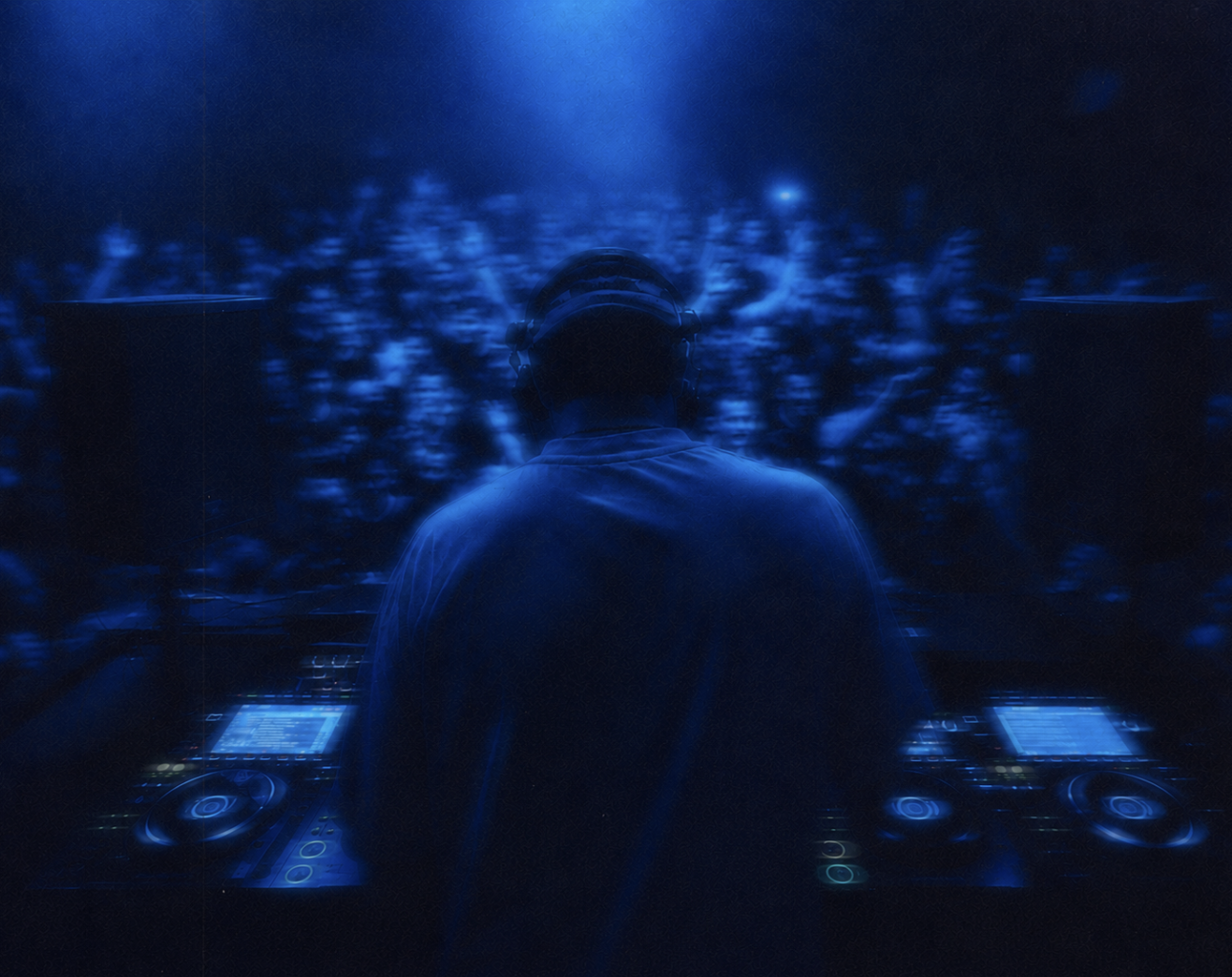 Mulsh performing a DJ set in front of a packed crowd